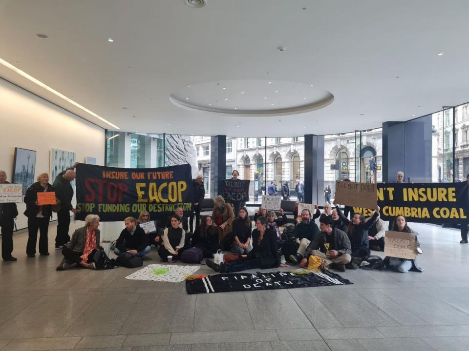 Fossil Free London protestors inside the office Talbot Insurance holding banners saying ‘Don’t Insure EACOP’ and ‘Don’t Insure West Cumbria Mine’ (Handout/Fossil Free London)