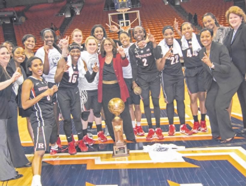 Rutgers head coach C. Vivian Stringer and her team pose with the trophy after winning the WNET championship game against UTEP.