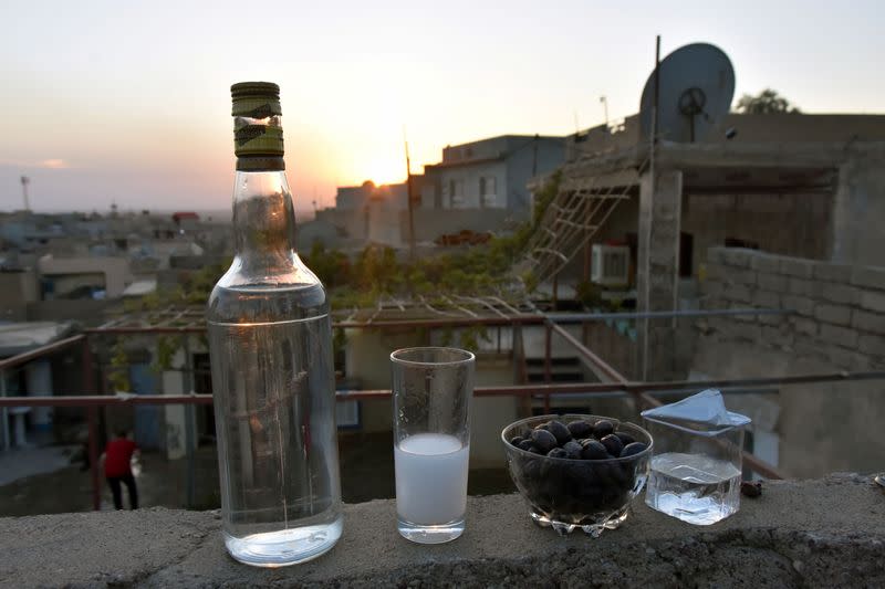 A glass of Arak produced out of dates by Saad Hussein, an Iraqi Yazidi, is pictured on the outskirts of Mosul