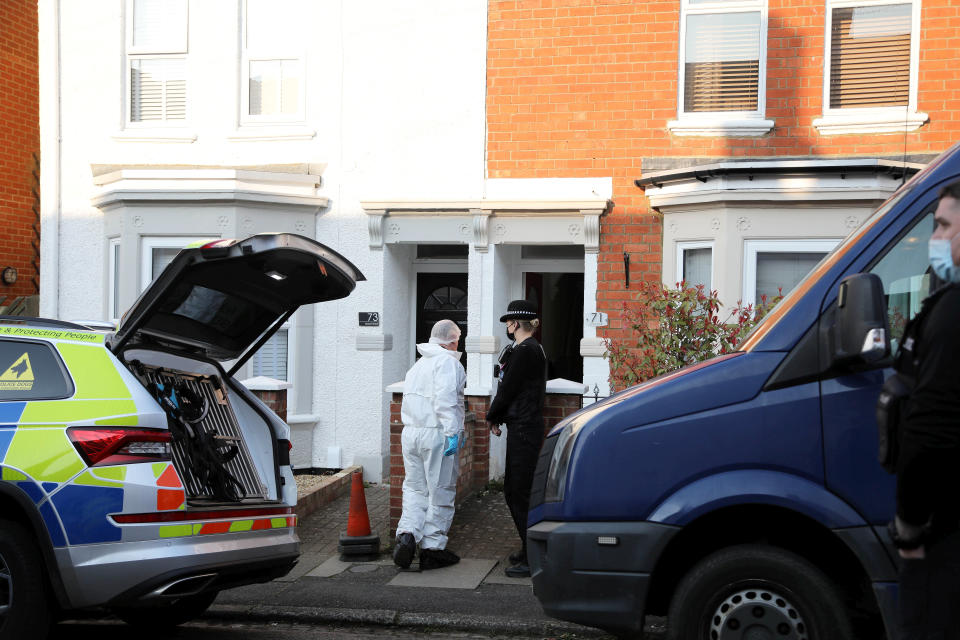 Police outside the couple's home in Northampton. (SWNS)