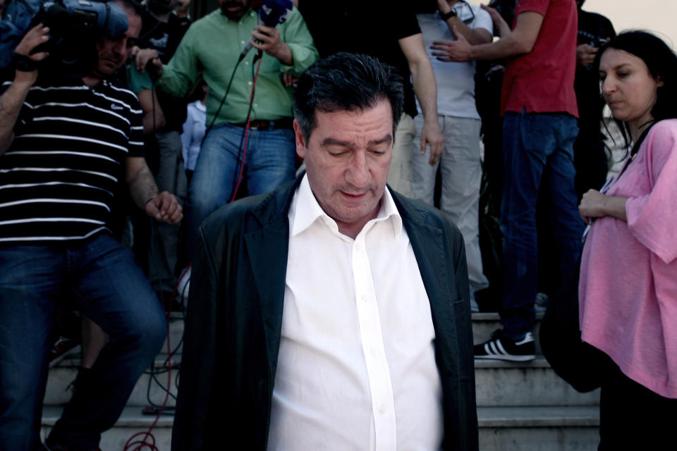 Athens mayor Giorgos Kaminis leaves on May 2, 2013 in Athens, after riot police had to use tear gas to disperse around 100 supporters of Greek neo-Nazi party Golden Dawn gathered in Syntagma square, below the parliament, for a food distrubition addressed strictly to Greeks. (ANGELOS TZORTZINIS/AFP/Getty Images)