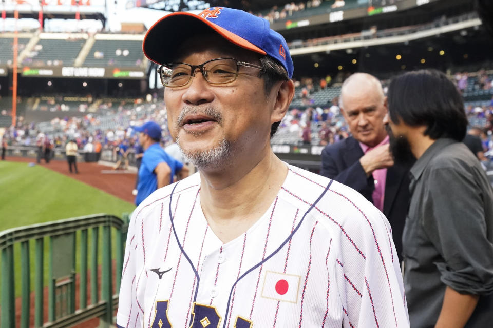 The Japanese consul-general in New York, Ambassador Mikio Mori, waits to throw out a ceremonial first pitch before a baseball game between the New York Mets and the Colorado Rockies, Thursday, Aug. 25, 2022, in New York. (AP Photo/Frank Franklin II)