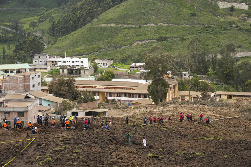 Rescue work is carried out at the site of a deadly landslide that buried dozens of homes in Alausi, Ecuador, Monday, March 27, 2023. (AP Photo/Dolores Ochoa)