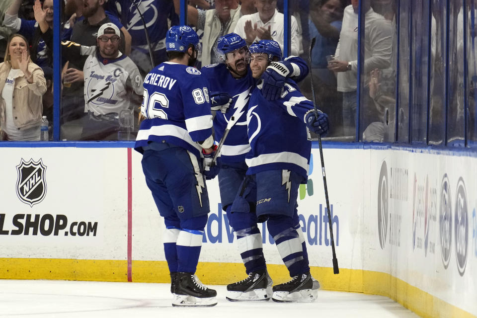 Tampa Bay Lightning center Brayden Point (21) celebrates his goal against the Detroit Red Wings with left wing Alex Killorn (17) and right wing Nikita Kucherov (86) during the third period of an NHL hockey game Thursday, April 13, 2023, in Tampa, Fla. (AP Photo/Chris O'Meara)