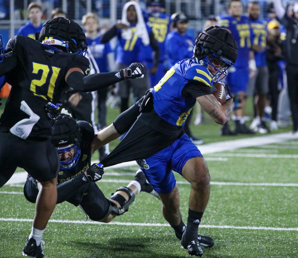 Delaware wide receiver Santino Correa struggles into the end zone for a score on the final play of the night as he is dragged down by defensive lineman Amin Mimouni during the Blue and White Spring Game at Delaware Stadium, Friday, April 19, 2024.