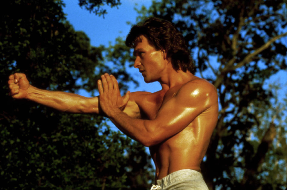 A shirtless man stands in a fighting pose