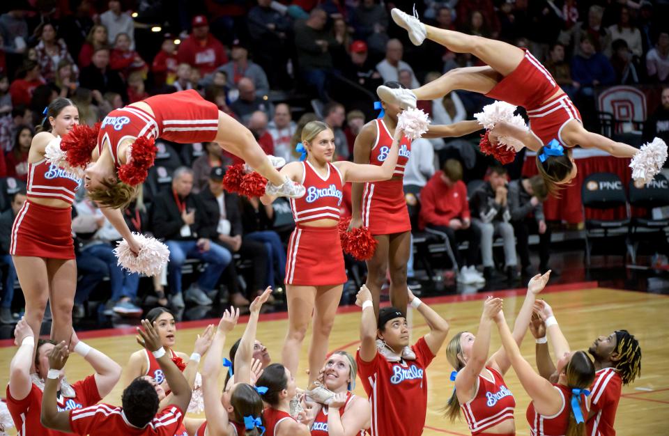 Bradley cheerleaders perform aerial backflips during a timeout as the Braves battle Southern Illinois in the second half of their Missouri Valley Conference basketball game Wednesday, Feb. 28, 2024 at Carver Arena in Peoria. The Braves routed the Salukis 86-67 in the last home game of the season.