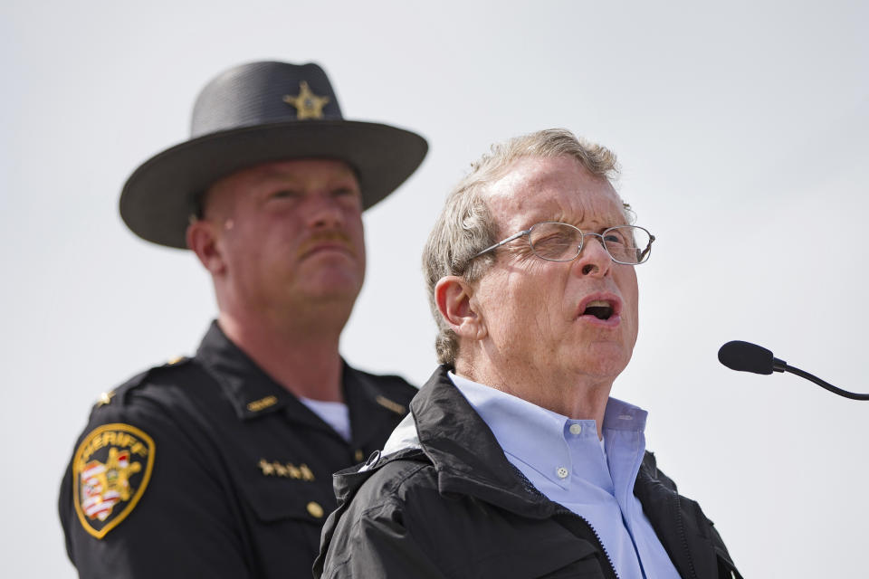 FILE – In this April 27, 2016, file photo, Ohio State Attorney General Mike DeWine, right, speaks to reporters alongside Pike County Sheriff Charles Reader, left, during a news conference in Waverly, Ohio. DeWine and Reader planned a news conference Thursday, April 13, 2017, about the unsolved killings of seven adults and a teenage boy from the Rhoden family whose bodies were found at four homes near Piketon, Ohio, on April 22, 2016, as the anniversary of the massacre approaches. (AP Photo/John Minchillo, File)