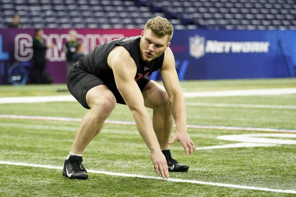 Michigan defensive lineman Aidan Hutchinson (31) participates in a drill at the NFL football scouting combine in Indianapolis, Saturday, March 5, 2022. (AP Photo/Steve Luciano)