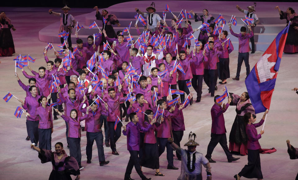 Cambodia's team hold flags during the opening ceremony of the 30th South East Asian Games at the Philippine Arena, Bulacan province, northern Philippines on Saturday, Nov. 30, 2019. (AP Photo/Aaron Favila)