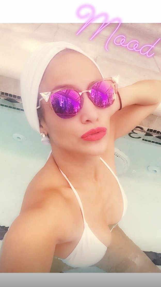 Jennifer Lopez started her long holiday weekend with some pool time. J. Lo takes a selfie in the water wearing red lipstick and a white bikini with the caption: "Mood."