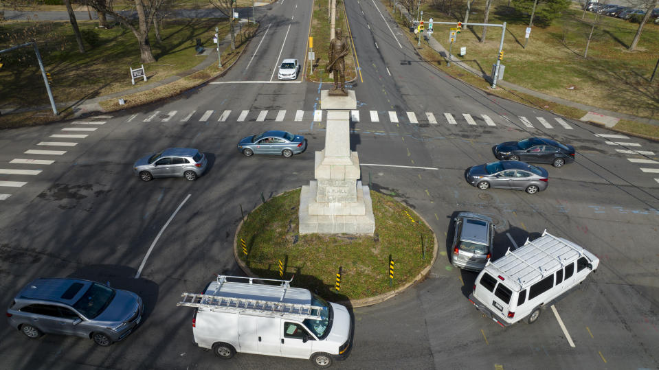 FILE - Traffic drives in the circle at the monument of confederate General A.P. Hill, which contains his remains, is in the middle of a traffic circle on Arthur Ashe Blvd. Jan. 6, 2022, in Richmond, Va. Work to relocate Richmond’s final city-owned Confederate monument should start this week after a judge refused a request to delay the removal of the statue of Gen. A.P. Hill from its prominent spot in Virginia's capital, an official said. (AP Photo/Steve Helber, File)