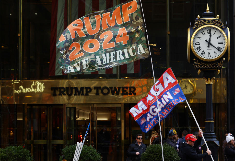 Supporters of  Donald Trump waves flags marked 