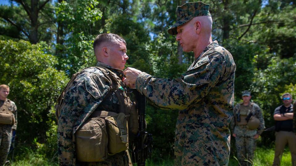 Cpl. Peyton Nott is promoted to sergeant by Gen. Eric Smith on Camp Lejeune, North Carolina, July 25. (Sgt. Rachaelanne Woodward/Marine Corps)