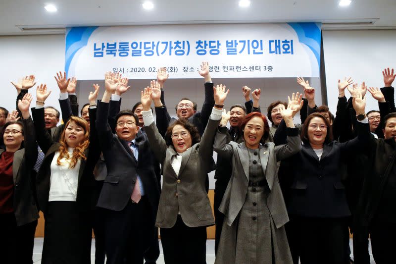 A group of North Korean defectors pose for photographs during the launching ceremony of their political party South-North Unification Party in Seoul