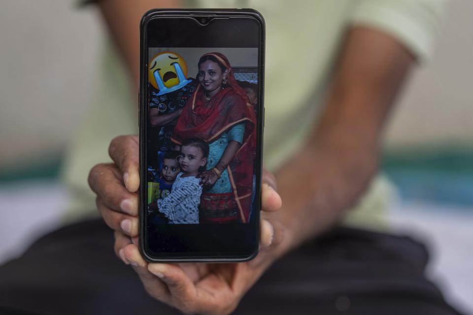 Arif Shamdar displays a photograph of his wife and two children on his phone in Morbi town of western state Gujarat, India, Tuesday, Nov. 1, 2022. “Everyone I loved is dead,” said Shamdar, whose wife Aneesa and two children, Aliya and Afreed, died in a bridge that collapsed on Sunday. (AP Photo/Rafiq Maqbool)