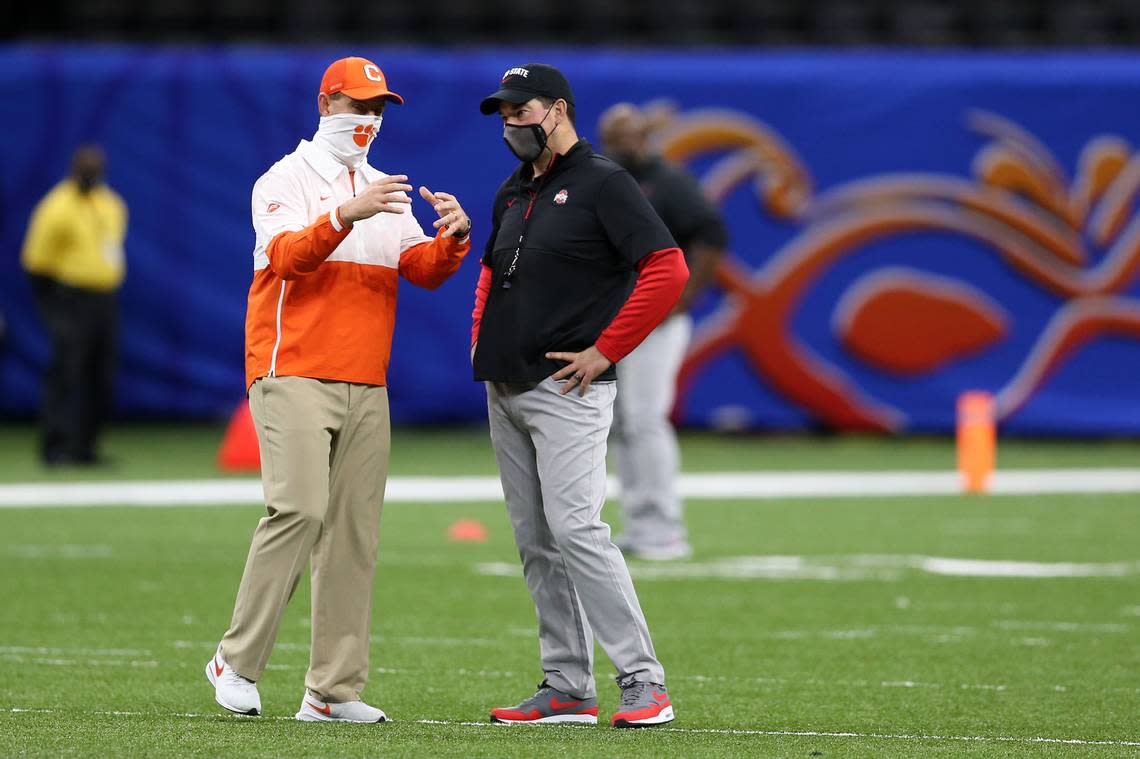 Jan 1, 2021; New Orleans, LA, USA; Clemson Tigers head coach Dabo Swinney (L) meets with Ohio State Buckeyes head coach Ryan Day (R) prior to the game at Mercedes-Benz Superdome.