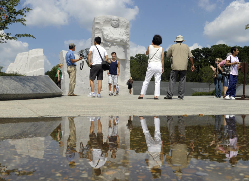 Visitots at The Martin Luther King, Jr., Memorial in Washington, Tuesday, Aug. 28, 2012. A year after the Martin Luther King Jr. Memorial opened to visitors on the National Mall, the group behind the monument is still working with the National Park Service to change an inscription quoting the civil rights leader and plans to bring new programs to the site. (AP Photo/Susan Walsh)