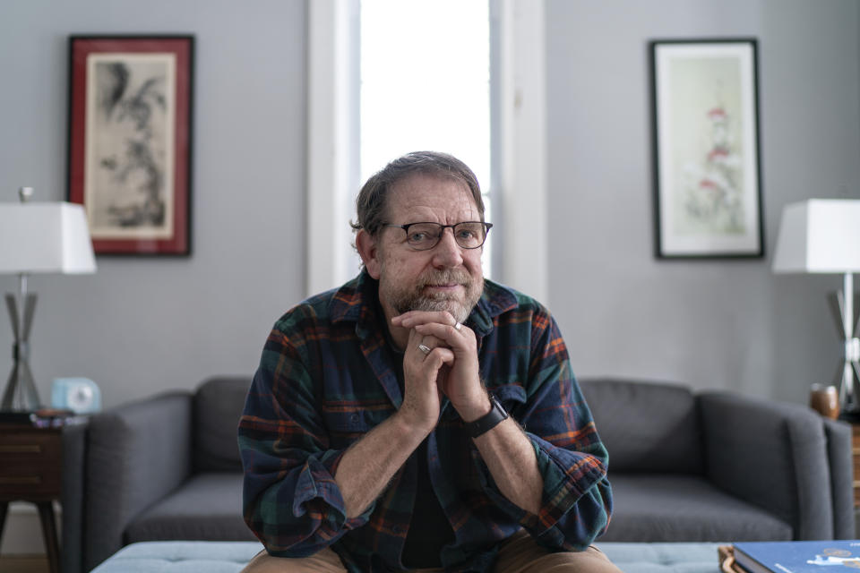 Paul Hambleton sits in his home in Hudson, Wis., Wednesday, Nov. 16, 2022. Hambleton, who works with the county Democratic party, says he takes comfort in the midterm election results, which even some Republicans say could signal a repudiation of Trump and his most extremist supporters."I don't feel the menace like I was feeling it before" the vote, he says. "I think this election showed that people can be brave, that they can stick their necks out." (AP Photo/David Goldman)