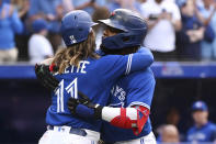 Toronto Blue Jays' Vladimir Guerrero Jr, right, and teammate Bo Bichette (11) celebrate Guerrero's two-run home run in the third inning of a baseball game against the Boston Red Sox in Toronto, Monday, June 27, 2022. (Jon Blacker/The Canadian Press via AP)