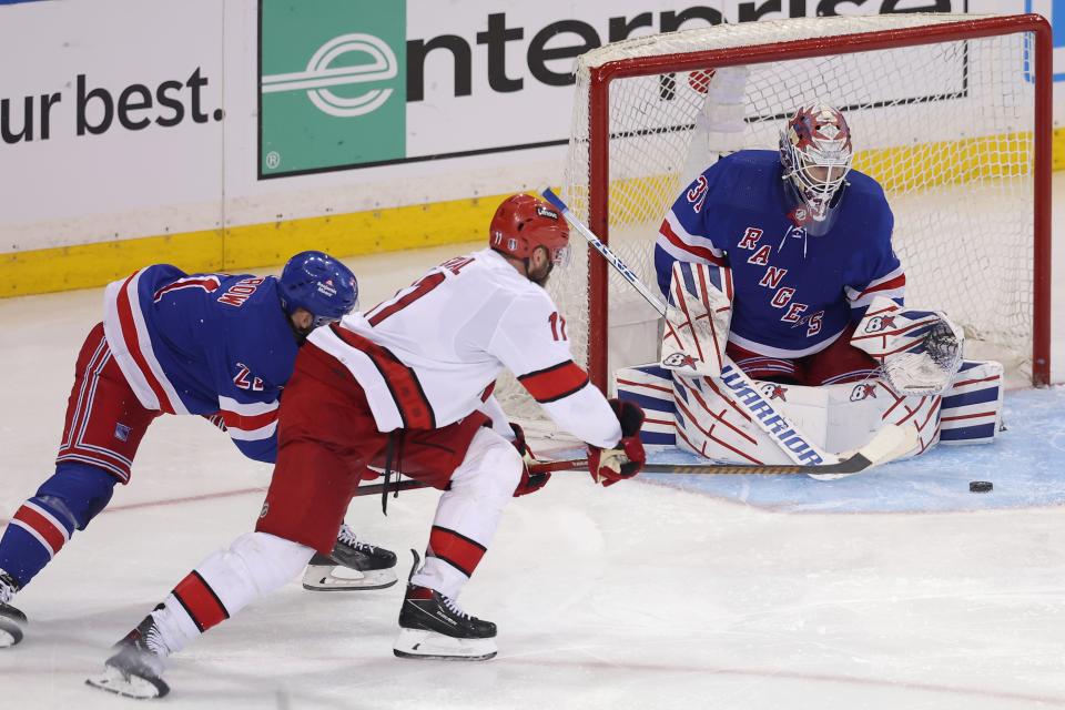 May 7, 2024; New York, New York, USA; New York Rangers goaltender Igor Shesterkin (31) makes a save against Carolina Hurricanes center Jordan Staal (11) in front of Rangers center Barclay Goodrow (21) during the second overtime of game two of the second round of the 2024 Stanley Cup Playoffs at Madison Square Garden. Mandatory Credit: Brad Penner-USA TODAY Sports