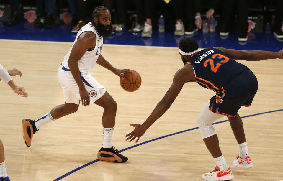 Los Angeles Clippers guard James Harden is defended by New York Knicks center Mitchell Robinson (23) during the first half of an NBA basketball game, Monday, Nov. 6, 2023, in New York. (AP Photo/John Munson)