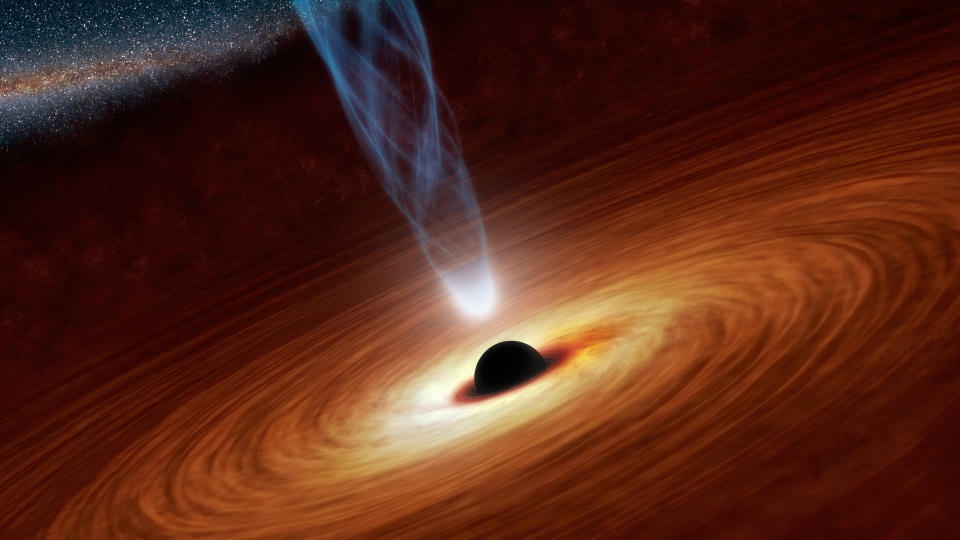 This artist's concept illustrates a supermassive black hole with millions to billions times the mass of our sun. Supermassive black holes are enormously dense objects buried at the hearts of galaxies. (NASA/JPL-Caltech)