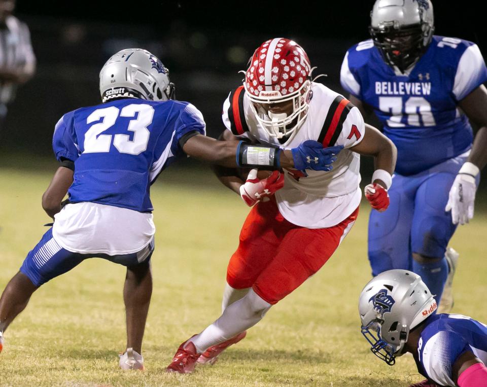 Dunnellon wide receiver Chris Henry (7) tries to escape Belleview defensive back Tahj Alderman (23) as Dunnellon visited Belleview on Oct. 7, 2022.