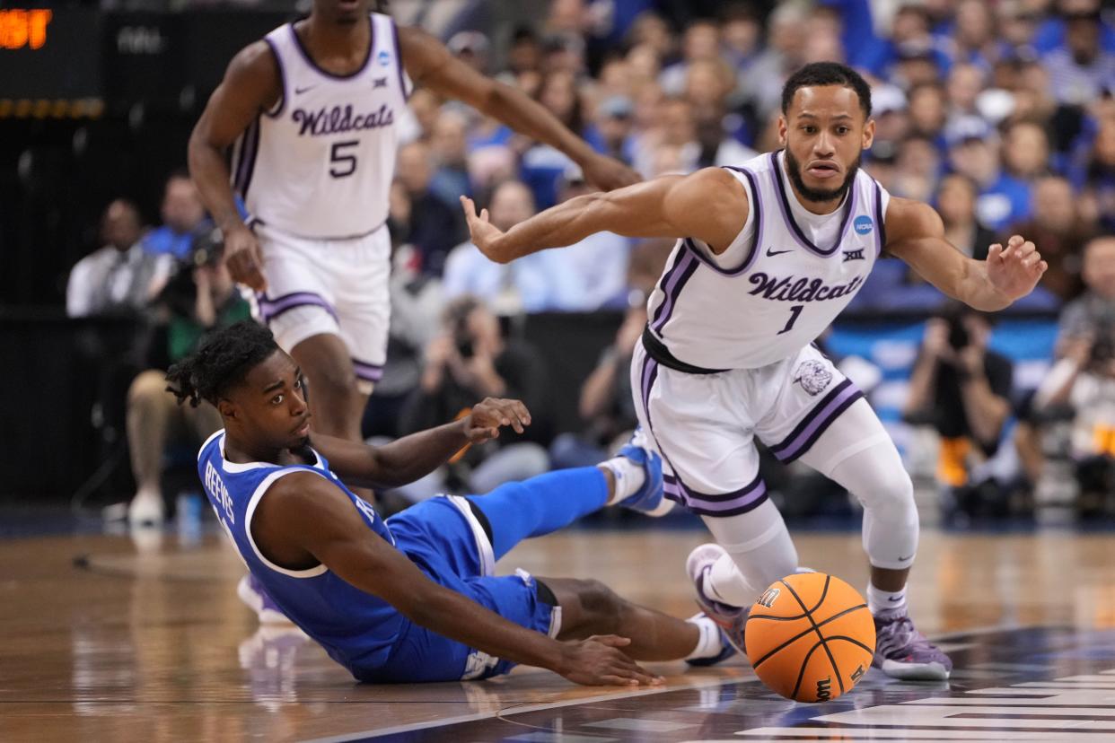 Kansas State point guard Markquis Nowell (1) and Kentucky's Antonio Reeves (12) go after a loose ball during their NCAA Tournament second-round game Sunday at Greensboro Coliseum.