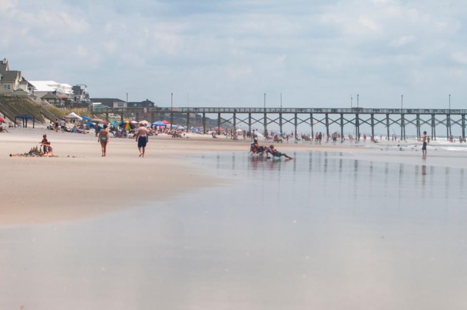 Beach goers spend the day in the water and on the beach at Topsail Beach, NC, on Friday, July 13, 2018.