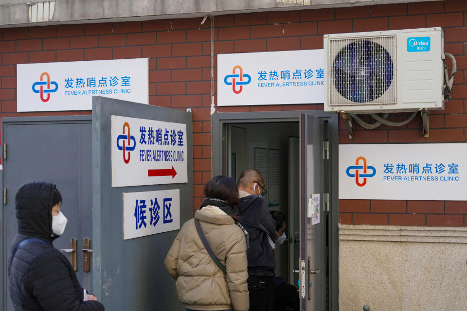 SHANGHAI, CHINA - DECEMBER 24: People queue up to receive treatment at a fever alertness clinic on December 24, 2022 in Shanghai, China. Starting on Monday, a total of 2,594 fever clinics in community health centers across Shanghai started to treat patients as COVID-19 infections surge. (Photo by VCG/VCG via Getty Images)