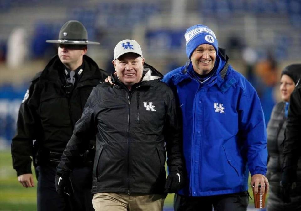 Kentucky Coach Mark Stoops, left, and Athletics Director Mitch Barnhart, right, are among those thought to be leading the charge for keeping Southeastern Conference football schedules with no more than eight league games each season.