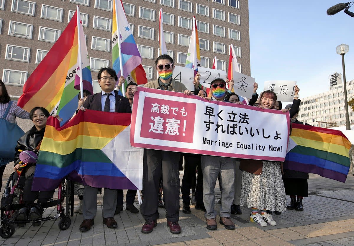 Plaintiffs and others shows a banner in front of Sapporo Hight Court in Sapporo, Hokkaido, northern Japan Thursday (AP)