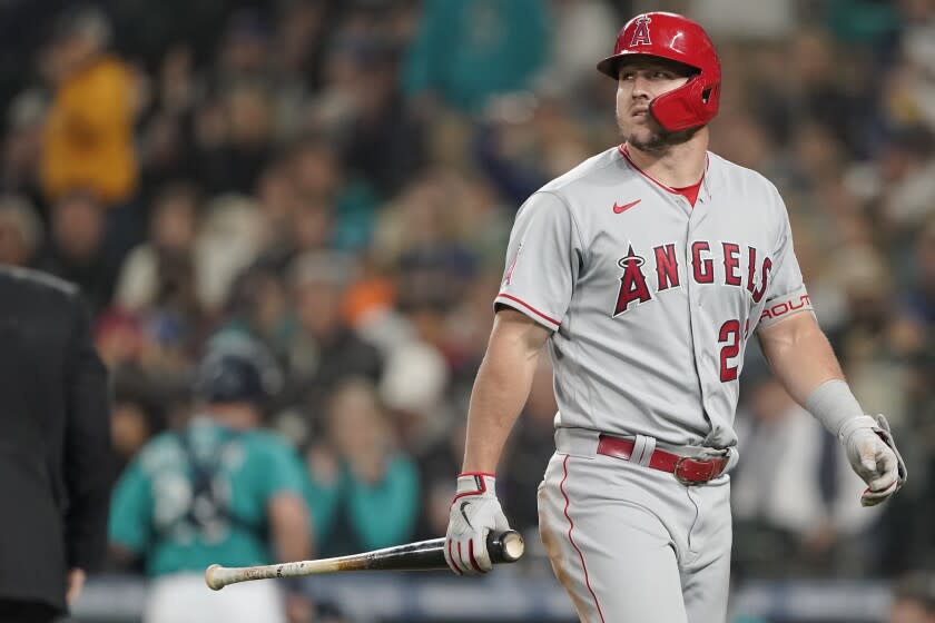 Los Angeles Angels' Mike Trout carries his bat after he struck out swinging.