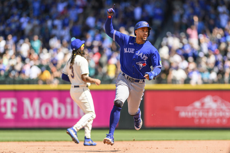 Toronto Blue Jays' George Springer gestures as he rounds the bases after Vladimir Guerrero Jr. hit a two-run home run during the fourth inning of a baseball game against the Seattle Mariners, Sunday, July 23, 2023, in Seattle. (AP Photo/Caean Couto)