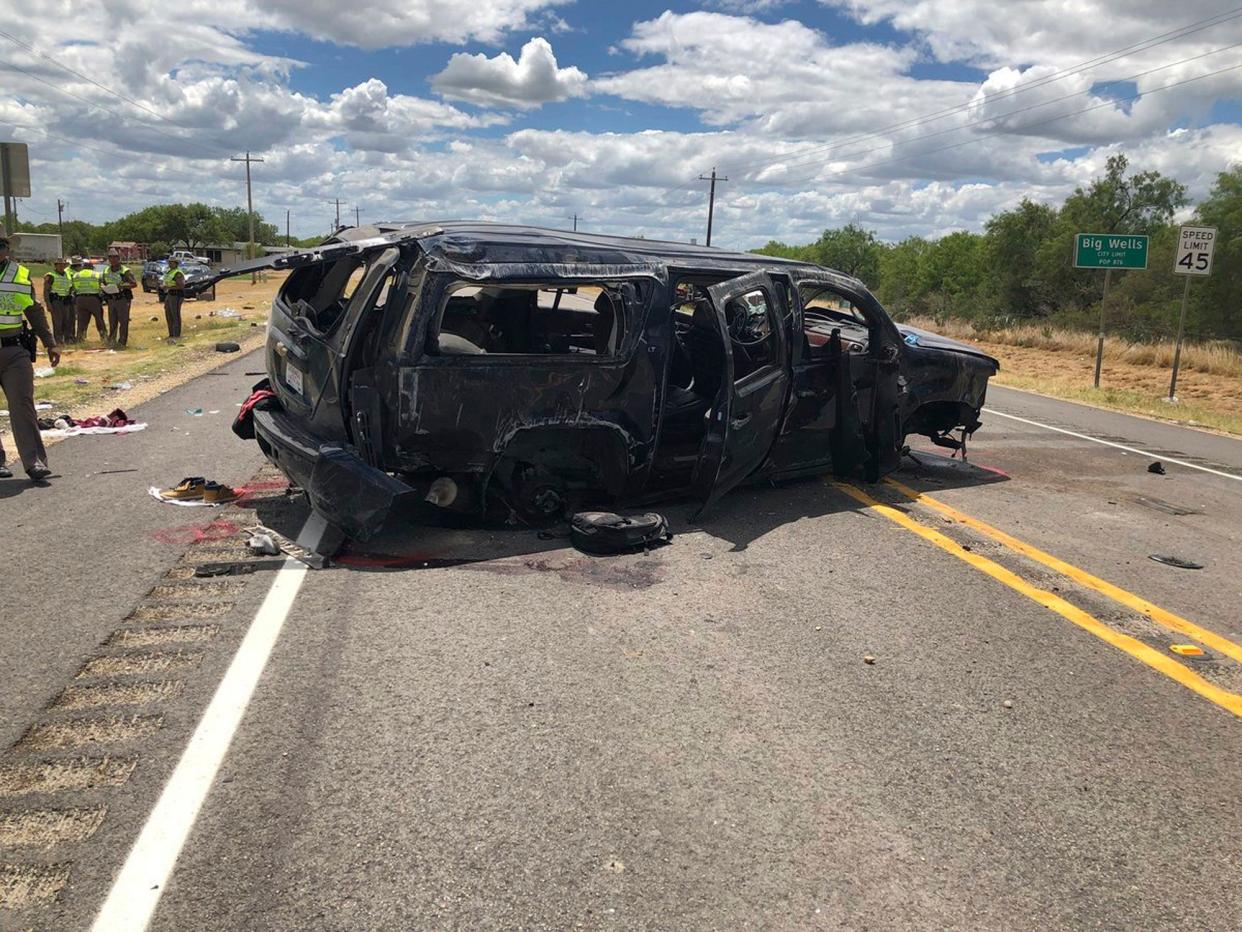 Damaged SUV is seen on Texas Highway 85 in Big Wells, Texas, after crashing while carrying more than a dozen people fleeing from Border Patrol agents, Sunday, June 17, 2018: David Caltabiano/KABB/WOAI via AP