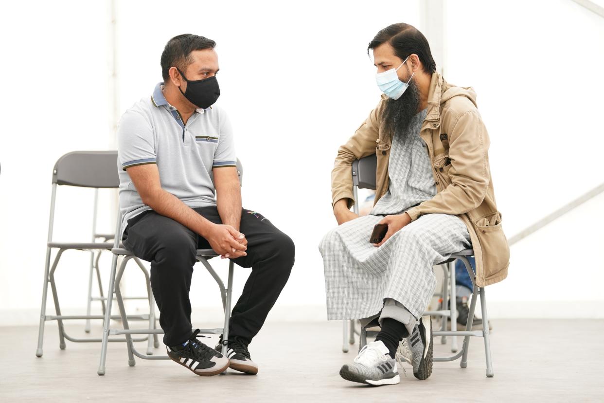 Men wait for a Covid-19 jab at a pop-up vaccination centre during a four-day vaccine festival in Langdon Park, Poplar, east London (Kirsty O’Connor/PA) (PA Wire)