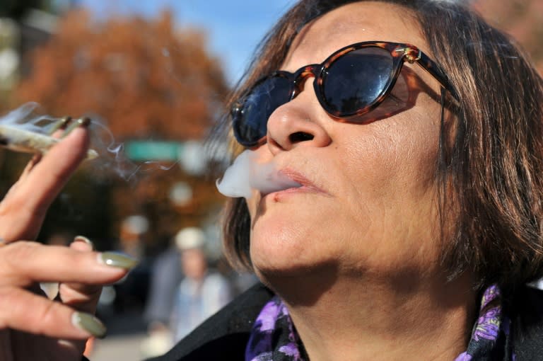 Anne Genovy smokes marijuana in Vancouver, Canada, as nearly a century of marijuana prohibition came to an end