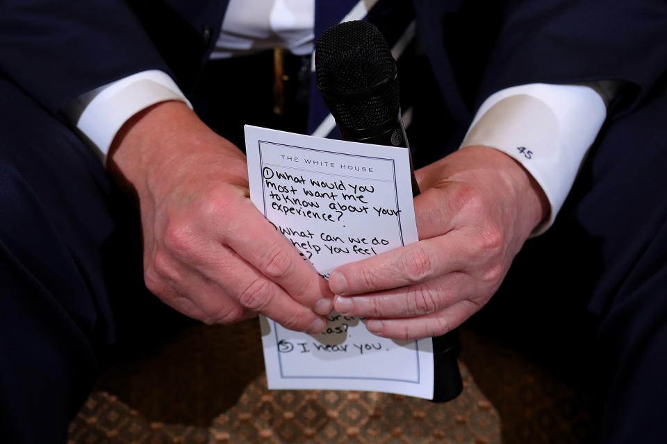 Trump received backlash after being seen holding a notecard reminding him to tell shooting victims and families that "I hear you." (Photo: Chip Somodevilla via Getty Images)