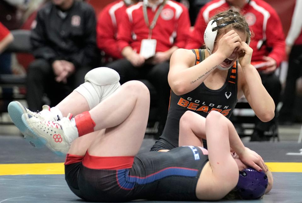 Mar 10, 2024; Columbus, Ohio, USA; MarysvilleÕs Cami Leng mourns her loss as Gibsonburg junior Morgan Leonhardt celebrates in the 115 weight class during the Ohio State Wrestling Final round at Value City Arena.