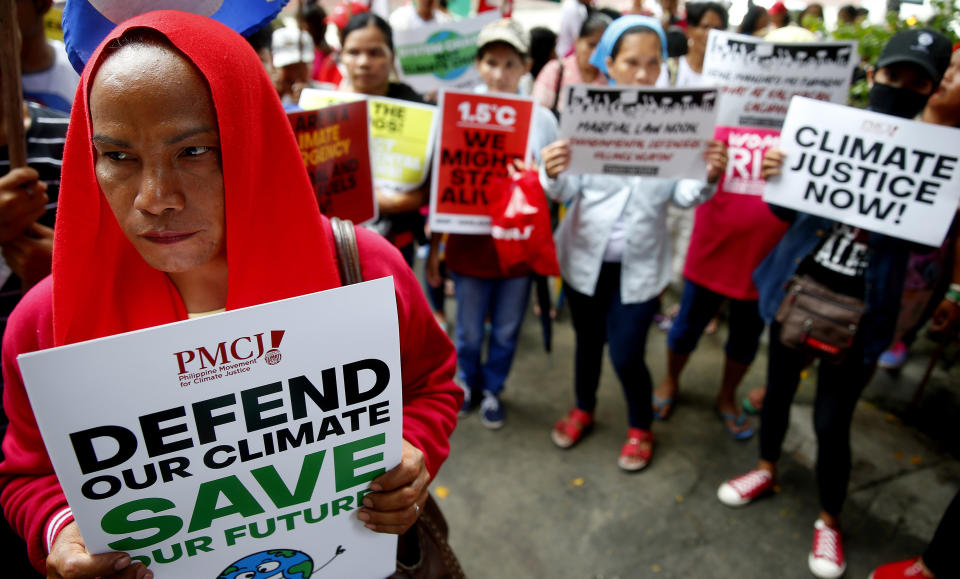 Environmental activists hold placards during a rally outside the Department of Environment and Natural Resources to coincide with the global protests on climate change Friday, Sept. 20, 2019 at suburban Quezon city, northeast of Manila, Philippines. Various environmental groups in the country are participating in what is expected to be the world's largest mobilization on climate change known as "Global Climate Strikes." (AP Photo/Bullit Marquez)