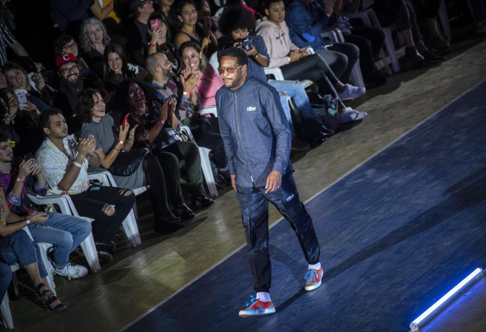 Cuban track and field legend Javier Sotomayor wears a creation from "Clandestina," the first Cuban independent urban fashion brand, during his launches for 2020 collection called Sports Glories in Havana, Cuba, Friday, Nov. 22, 2019. (AP Photo/Ramon Espinosa)