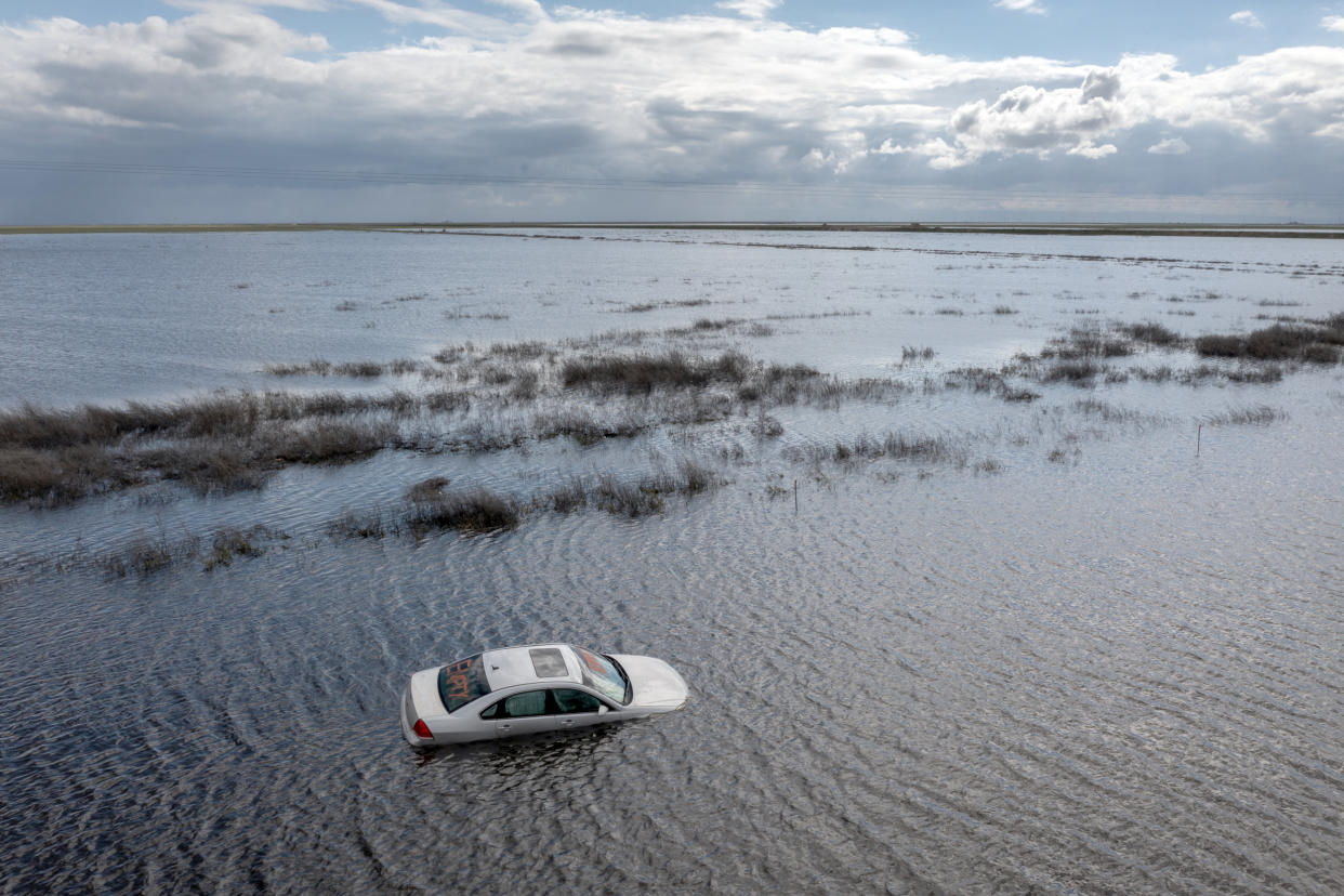 A car is left stranded on a flooded road near Corcoran, Calif., (David McNew / Getty Images file )