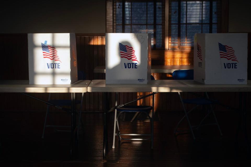 The shadow of a voter entering the precinct at St. Joseph Catholic Church in Gulckstadt is cast on a privacy divider for people filling out ballots during the primary election Tuesday, March 12, 2024.