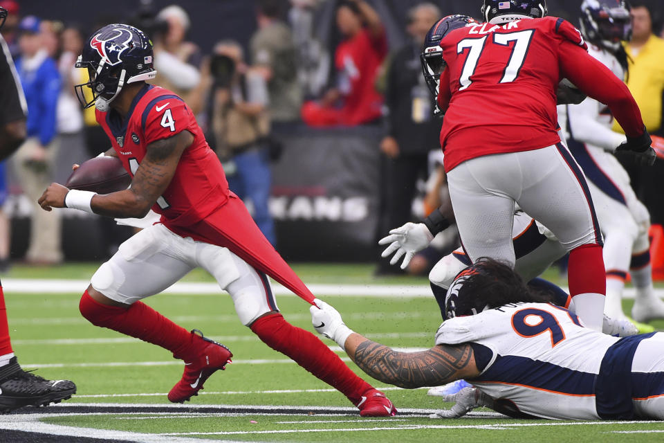 Houston Texans quarterback Deshaun Watson (4) is stopped by Denver Broncos nose tackle Mike Purcell (98) during the second half of an NFL football game Sunday, Dec. 8, 2019, in Houston. (AP Photo/Eric Christian Smith)