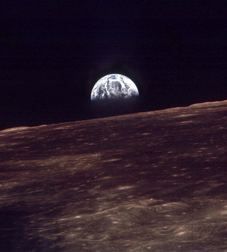 The Earth shines over the horizon of the Moon in this Dec. 24, 1968 photo shot by the astronauts on Apollo 8.