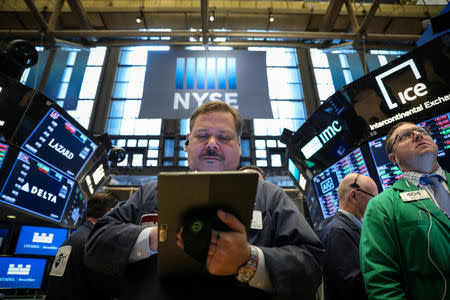 FILE PHOTO: Traders work on the floor at the New York Stock Exchange (NYSE) in New York, U.S., April 24, 2019. REUTERS/Brendan McDermid