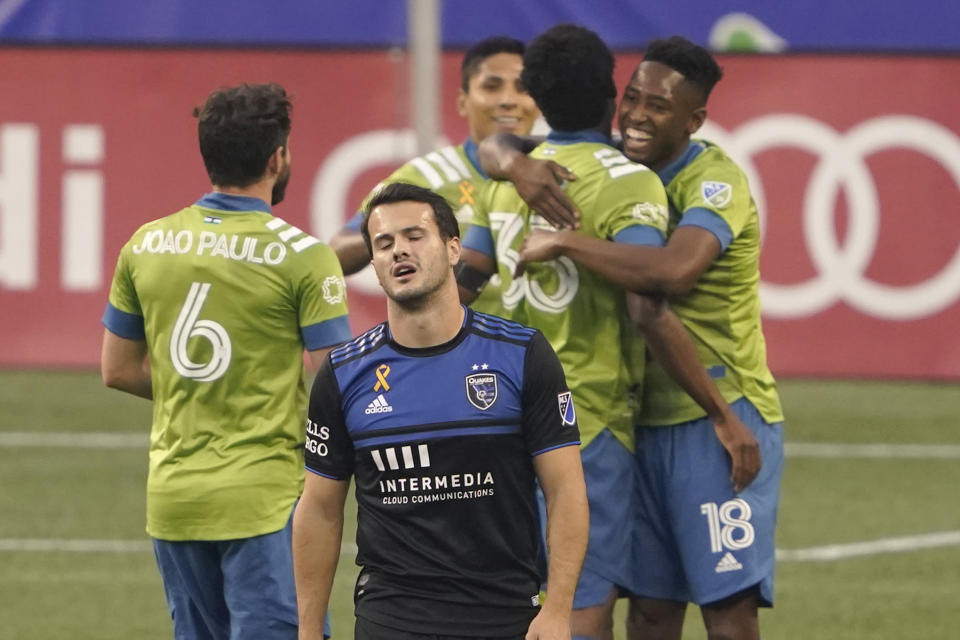 San Jose Earthquakes midfielder Vako, front, walks away as Seattle Sounders defender Kelvin Leerdam, right, celebrates with teammates after scoring a goal during the first half of an MLS soccer match Thursday, Sept. 10, 2020, in Seattle. (AP Photo/Ted S. Warren)