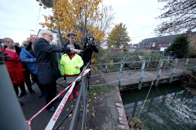 Labour leader Jeremy Corbyn (left) and former leader Ed Miliband (right) are shown the water level in Bentley, Doncaster
