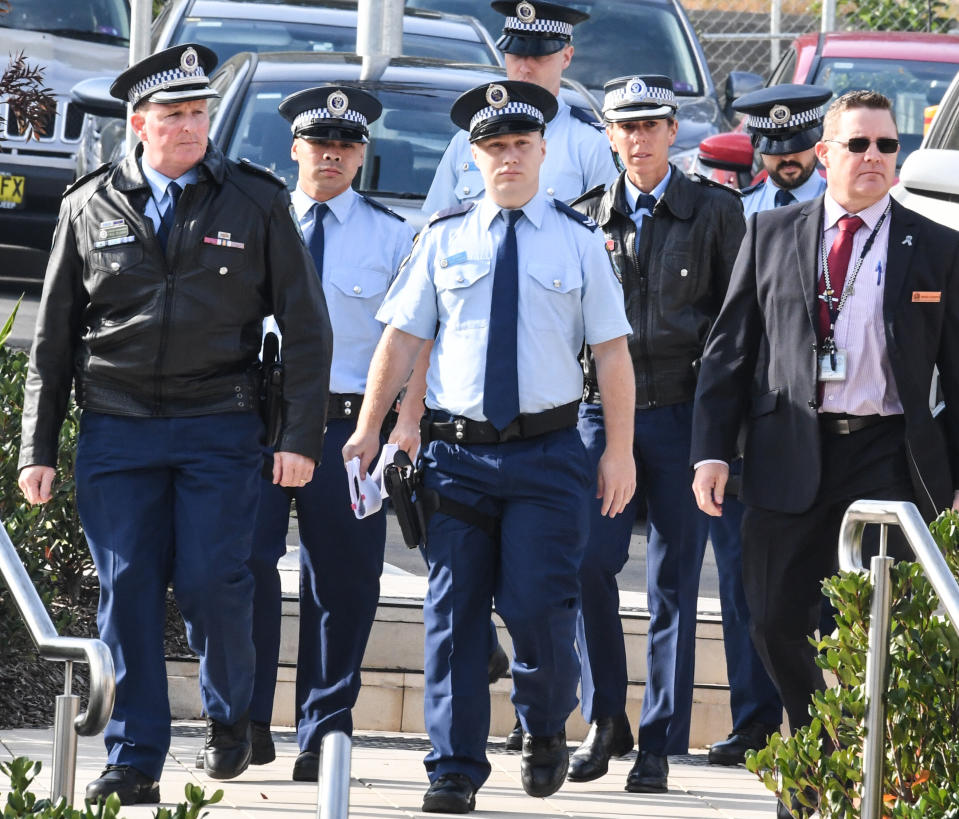 Arriving at the NSW Coroners Court on Monday are Senior Constables Frederick Tse (second from left) and Jakob Harrison (third from left) with other police officers.